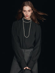 Blusa con maniche a sbuffo e collo finto