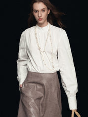 Blusa con maniche a sbuffo e collo finto